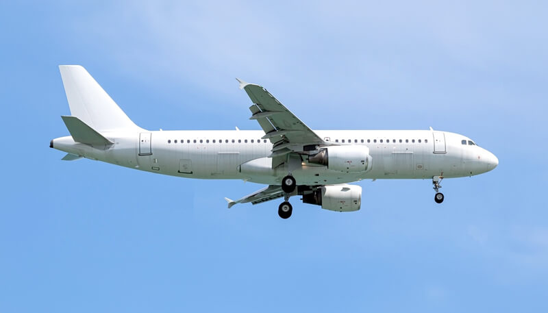 An Airbus A320-214 aircraft flying in the sky operated by Dela World Charter.