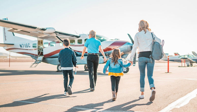 A family boarding a plane for an emergency charter by Dela World Charter.