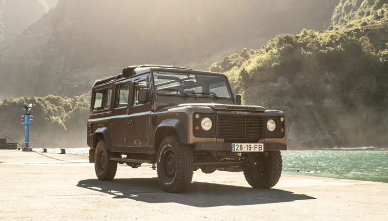 A Land Rover Defender ready to collect guests from a private jet for a hunting trip.