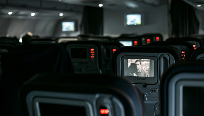 In-flight entertainment on a commercial charter aircraft operated by Dela World Charter.